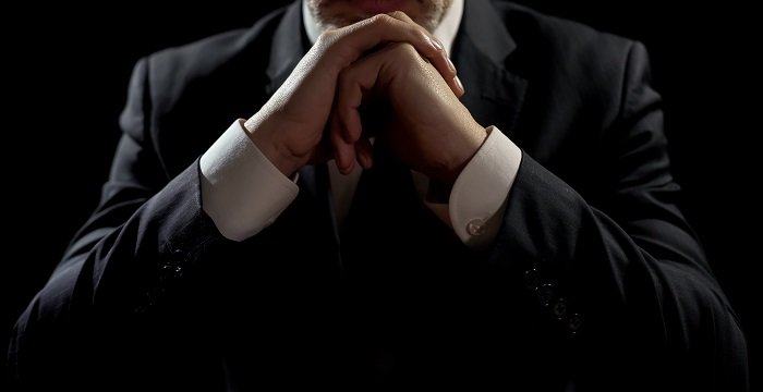 Businessman leaning on elbows, professional lawyer listening patiently to client