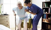 Nurse helping senior woman to stand