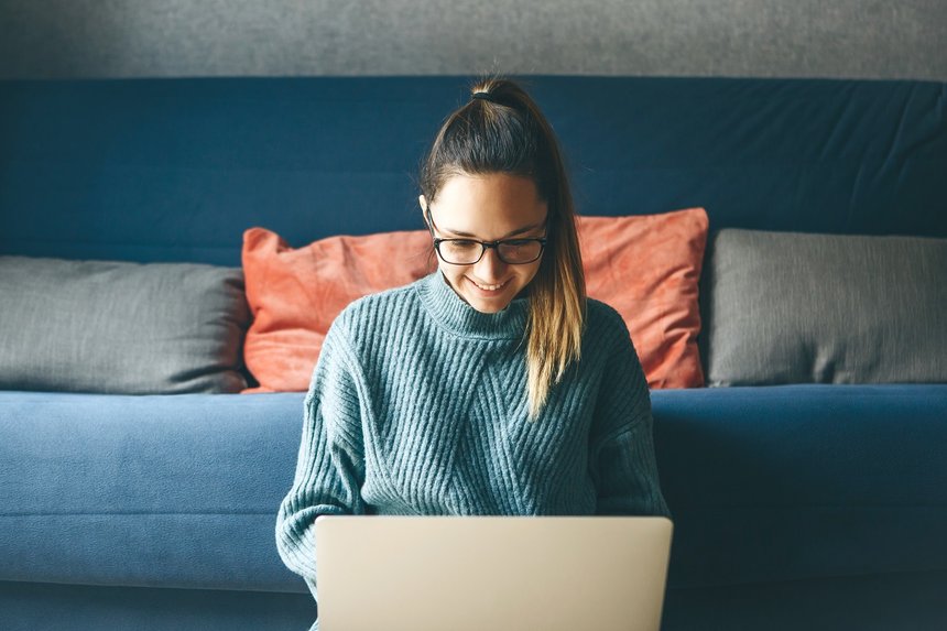 Girl working on laptop from home or student studying from home or freelancer. Or she is watching a video or using the Internet