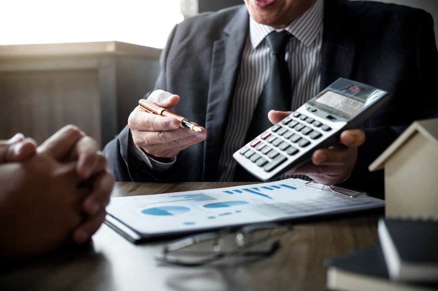 Real estate broker agent being analysis and making the decision a home estate loan to customer, Agent man is using calculator to presentation detail and waiting for his reply to finish