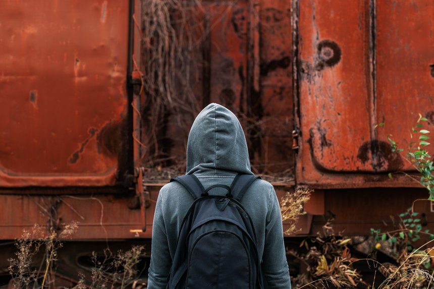 Homeless woman with backpack getting away from it all