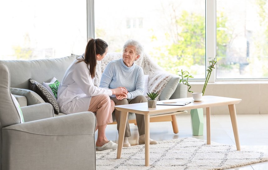 Doctor with senior woman in nursing home