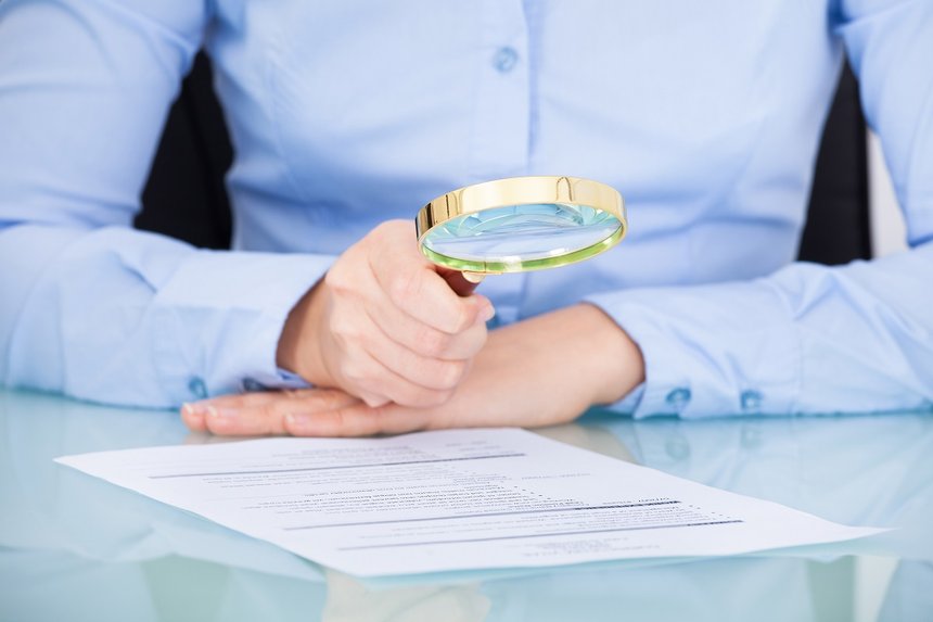 Businesswoman Holding Magnifying Glass