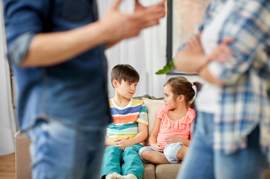 family problem, conflict and people concept - sad children watching their parents quarreling at home