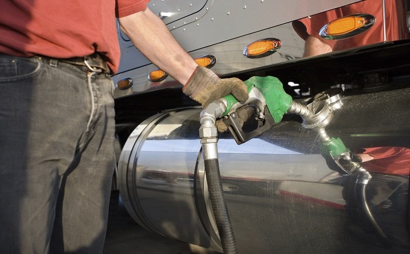 Man fueling Up a Freight Transport Truck