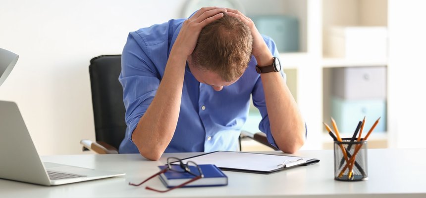 Man having panic attack at workplace in office