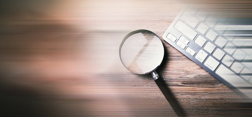 Internet search concept, magnifier and computer keyboard