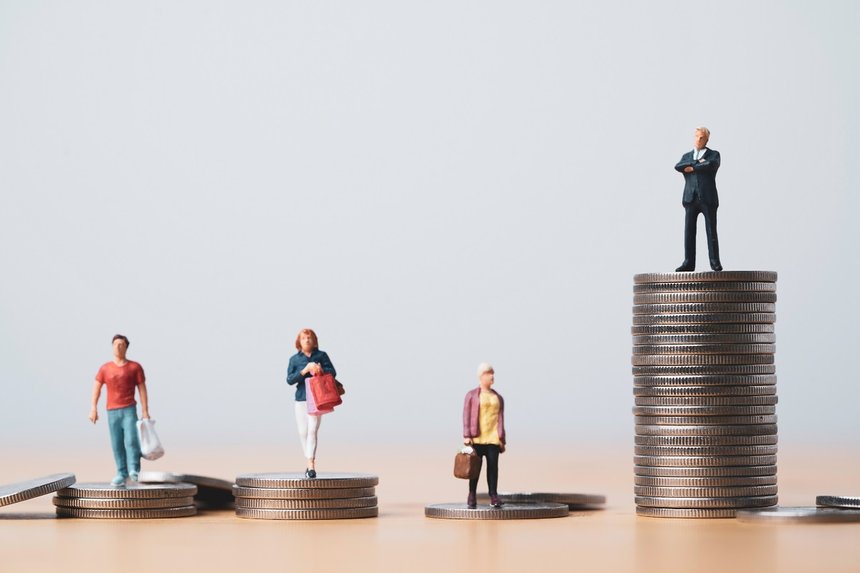 Businessman standing on highest coins stacking and shopper stand