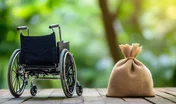 A wheelchair alongside a money bag on a natural green background, emphasizing the importance of saving for mutual funds and retirement for individuals with disabilities and ensuring financial security