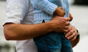 Intimate gesture of trust between a father and his son