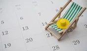 Green beach chair and hat on white blank calendar background copy space. Annual leave travel period for relaxation concept. Period of paid time off (PTO) granted to employees by their employer.