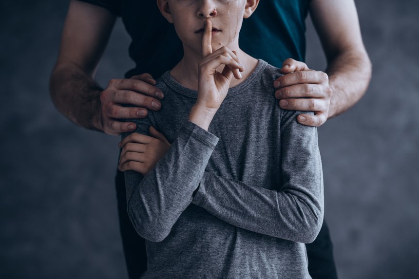 Gesture of silence, abused boy violence concept