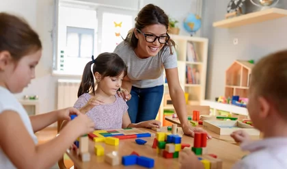 Preschool teacher with children playing with colorful wooden didactic toys at kindergarten