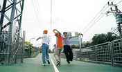 Back view of skilled hipster walking while turn around and looking at camera. Group of professional break dancer pose at camera and perform street dance foot step. Outdoor sport 2024. Sprightly.