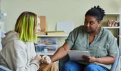 Psychologist working with upset girl at office
